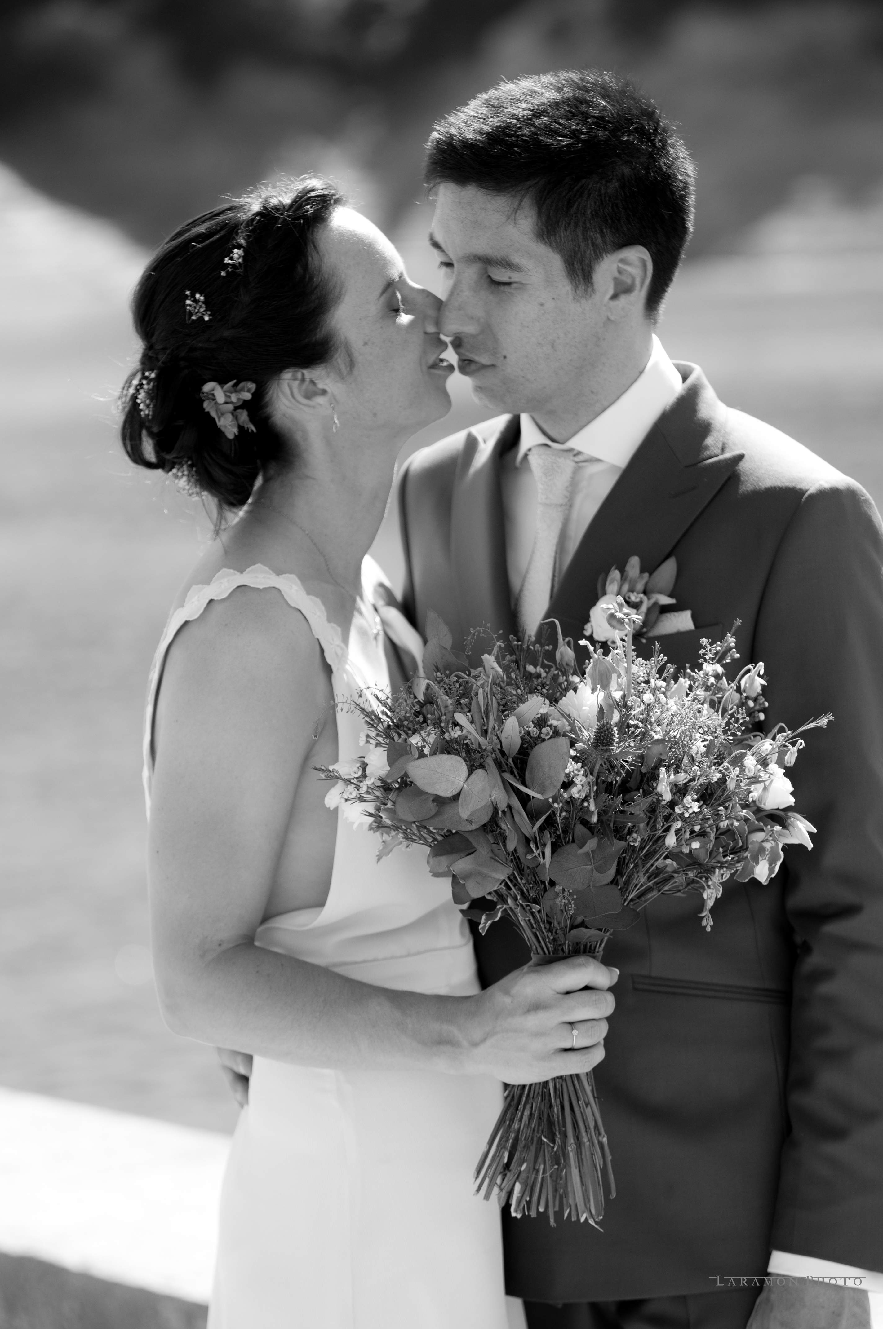 Smiling newlywed couple with mountain backdrop